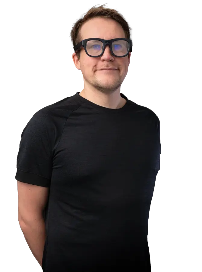 Mustapaitainen mieshenkilö katsoo kohti. Miehellä on päässään AR-lasit.